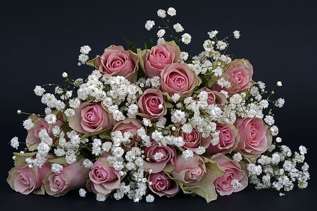 Svadobná kytica z ruží a bielych kvetov na čiernom pozadí